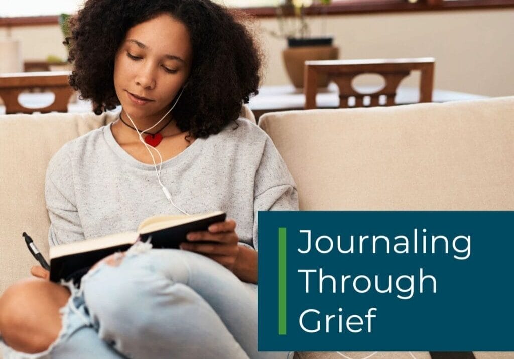 f WP F image Online Grief Support (2) Woman writes in journal while sitting on peacefully on the couch.